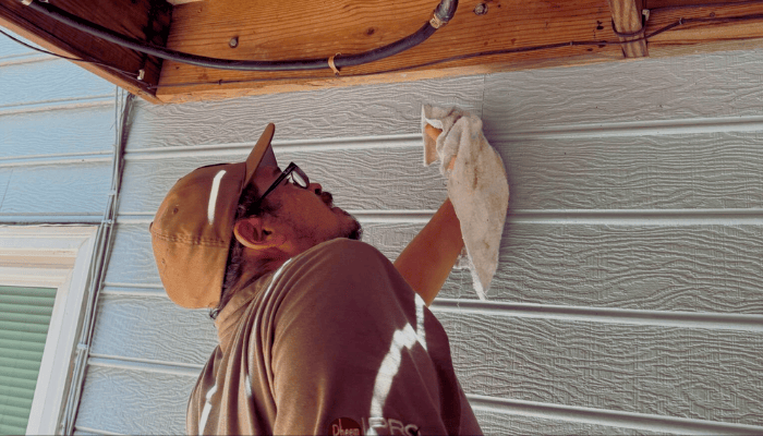 TKO Plumbing technician inspecting an outdoor water line