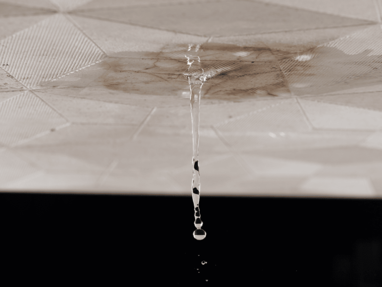 Water dripping from a ceiling caused by a hidden slab leak in a Georgia home.