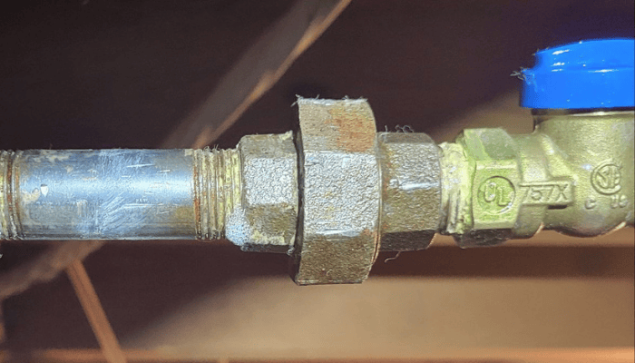 Close-up of a gas shutoff valve properly installed on a residential gas line